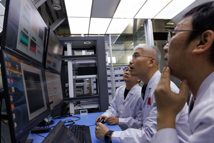 Researchers Li Gang, Liu Jianghua, and Zhou Benzhe (R-L) discuss the operational status of the all-superconducting magnet at the ultra-low temperature high magnetic field quantum oscillation experimental station of the Institute of Physics of the Chinese Academy of Sciences in Beijing, capital of China, on Jan. 26, 2026.   (Xinhua/Jin Liwang)